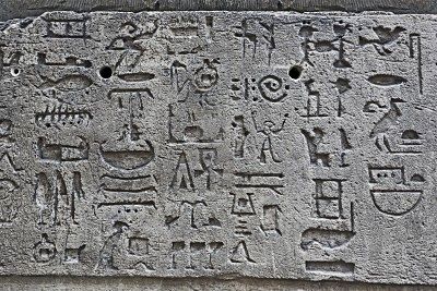 6961294-gray-monochromatic-ancient-stone-wall-with-egyptian-hieroglyphs-and-figures